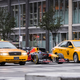 A photo of a Red Bull Formula 1 car lining up alongside two yellow New York City taxis.